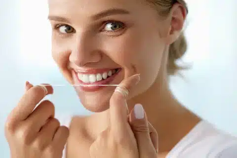 woman flossing smiling